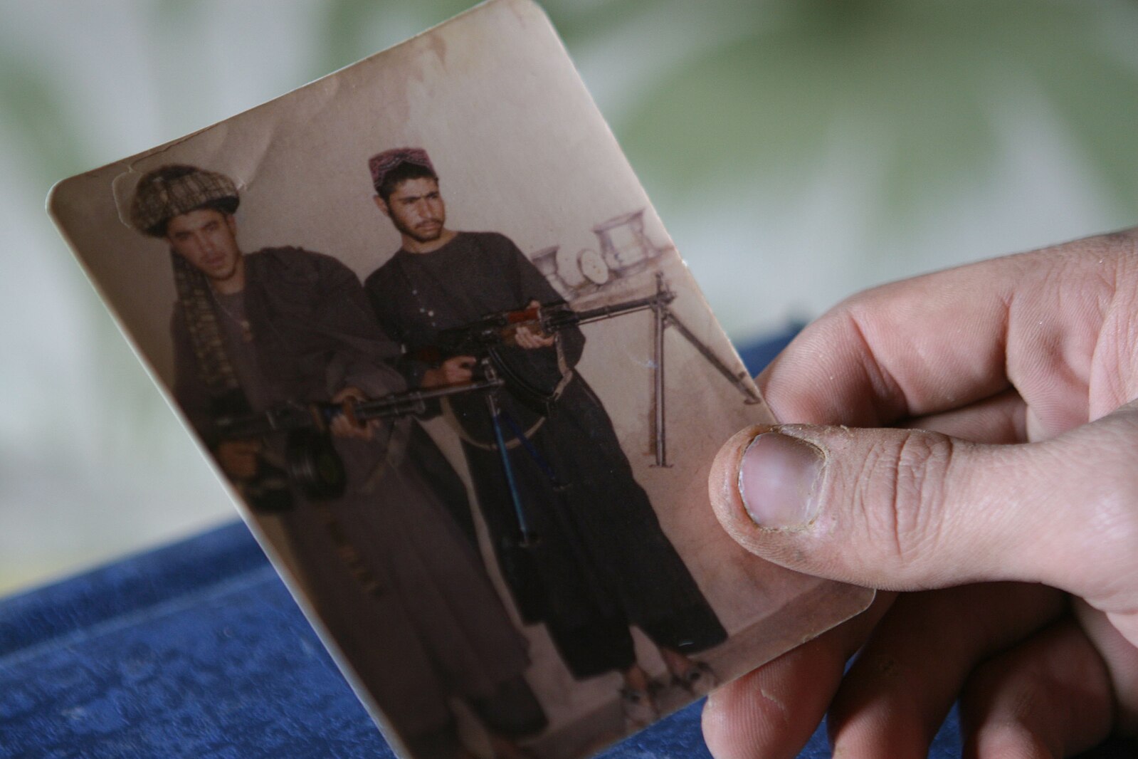 a photo of two men armed with Soviet-made, medium machine guns.